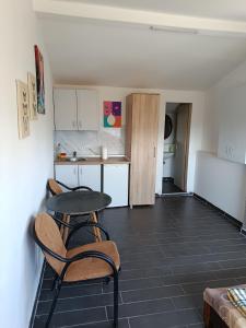 a kitchen with a table and two chairs and a refrigerator at Solara in Bar
