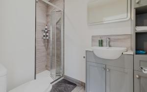 a bathroom with a shower and a toilet and a sink at Executive 2BR Business & Contractor Stay in Weston-super-Mare +8 photos