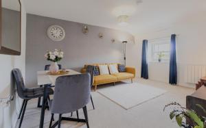 a living room with a table and a couch at Executive 2BR Business & Contractor Stay in Weston-super-Mare