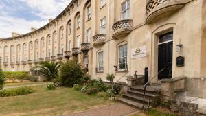 a large building with stairs leading to a door at Executive 2BR Business & Contractor Stay in Weston-super-Mare