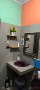 a bathroom with a sink and a mirror at La Casa Amarilla in Sololá