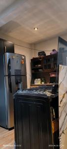 a kitchen with a black refrigerator in a room at La Casa Amarilla in Sololá