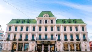 a building with a clock tower on top of it at Grand Hotel Traian in Iaşi