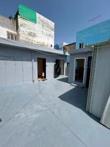 an empty parking lot in front of a building at casa celia in Asilah