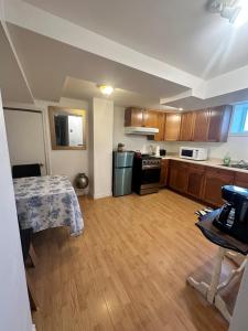 a small kitchen with a table and a kitchen with a tableablish at 1 Bedroom Basement Apartment Owen Sound in Owen Sound