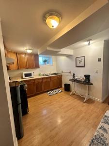 a kitchen with a table in the middle of it at 1 Bedroom Basement Apartment Owen Sound in Owen Sound