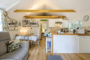 a kitchen and living room with a couch and a table at 1 Bed in Snape oc-9tts in Snape