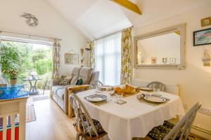 a dining room with a table and a living room at 1 Bed in Snape oc-9tts in Snape +18 photos