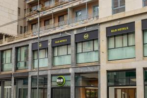 an office building with the ape properties sign on it at B&B HOTEL Milano Duomo Velasca in Milan