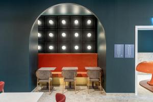a restaurant with a table and chairs in a room at B&B HOTEL Milano Duomo Velasca in Milan +68 photos