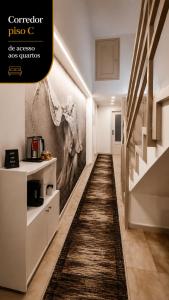 a hallway with a painting of a woman on the wall at Rooms4you 3 in historic center of Braga in Braga