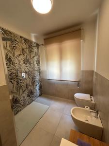 a bathroom with a toilet and a sink at Casa vacanza Giardinolago in Sale Marasino