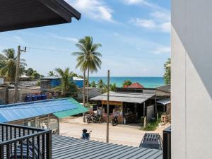 a view of the beach from the balcony of a building at Beachside Villa in Ko Phangan