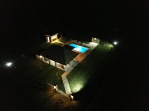 a house with a swimming pool at night at Čajića avlija pool house in Obrenovac