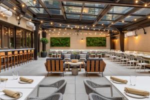 a restaurant with tables and chairs in a room at Arlo Washington DC in Washington, D.C.