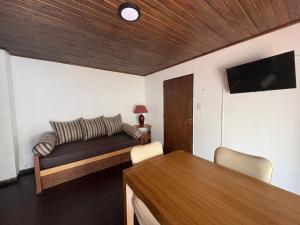 a living room with a couch and a table at Magnolia Tempo in Esquel +4 photos