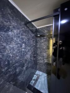 a person taking a picture of a shower in a bathroom at Irmouli in Sétif +18 photos