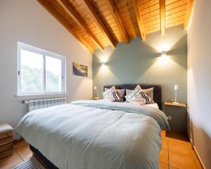 a bedroom with a large bed and a large window at Seashore Escape by Lisbeyond in Aljezur +11 photos