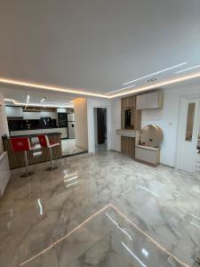 a large room with a kitchen and a living room at Irmouli in Sétif