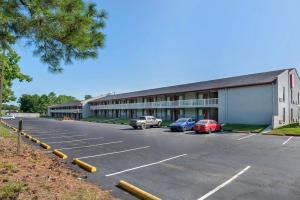 a building with cars parked in a parking lot at Red Roof Inn Doswell - Kings Dominion in Doswell