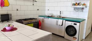 a kitchen with a sink and a washing machine at Lindas Vistas in Tías