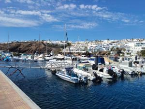 a group of boats docked in a marina with buildings at Lindas Vistas in Tías +20 photos