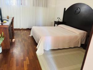 a bedroom with a large bed and a dresser at Agriturismo DonnoMarco in Simeri