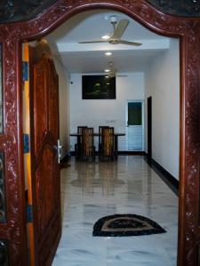 a hallway with a mirror and a dining room at Nilaveli Beach Haven in Nilaveli