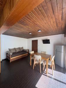 a living room with a table and a couch at Magnolia Tempo in Esquel
