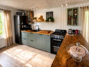 a kitchen with a stove and a counter top at Hjartarstaðir Private Country Retreat with Hot Tub in Hagi
