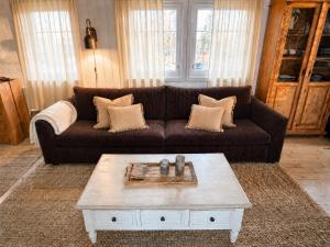 a living room with a couch and a coffee table at Hjartarstaðir Private Country Retreat with Hot Tub in Hagi