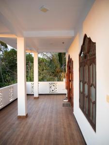 a hallway of a house with a wooden door at Nilaveli Beach Haven in Nilaveli