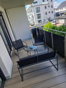 a patio with two chairs and a table on a balcony at Apartment Affengrün in Weyhausen