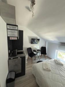 a bedroom with a bed and a table and chairs at Storm in Varna City