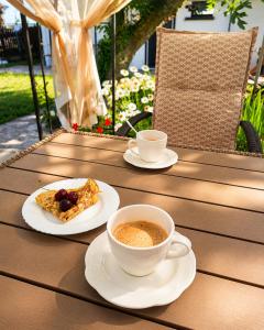 a table with two cups of coffee and a plate of food at Solmara in Lozenets +22 photos