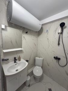 a white bathroom with a toilet and a sink at Storm in Varna City +23 photos