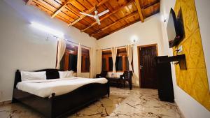 a bedroom with a bed and a desk in a room at Lotus Lake View Inn in Bhīm Tāl