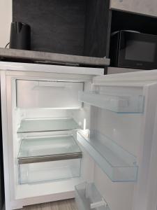 an empty refrigerator with its door open in a kitchen at Storm in Varna City