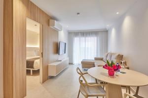 a living room with a table and a couch at Silken Atlantis Playa - Holiday Homes in Las Palmas de Gran Canaria