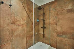 a bathroom with a shower with a glass door at Silken Atlantis Playa - Holiday Homes in Las Palmas de Gran Canaria +57 photos
