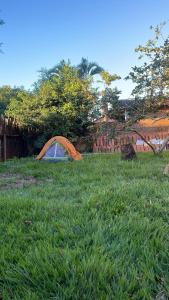 a tent sitting in the grass in a yard at Camping & Glamping For All in Itaúnas +23 photos