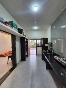 a kitchen with a counter top and a kitchen sidx sidx sidx at Todkars Villa in Kolhapur