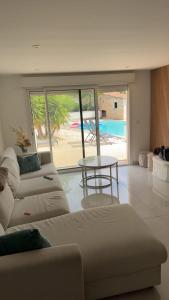 a living room with two white couches and a table at Azure Pool Villa in Marseille +9 photos