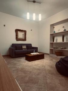 a living room with a couch and a coffee table at Sicilia Vacation rooms in Trapani