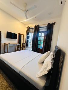 a bedroom with a large bed in front of a window at Cheff Hotel Vianuel in Kendwa