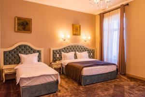 a hotel room with two beds and a window at Grand Hotel Traian in Iaşi +52 photos