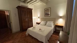 a bedroom with a bed with white sheets and pillows at Le charme de l'Arlésienne in Arles