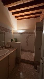 a bathroom with a sink and a toilet and a mirror at Le charme de l'Arlésienne in Arles