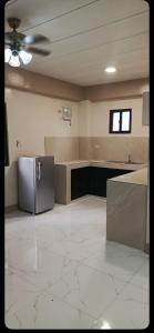 a kitchen with a refrigerator in the middle of a room at Melinda Place in Camarin +28 photos