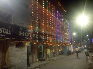 a building with christmas lights on a street at night at Hotel Raj Bed And Breakfast in Agra